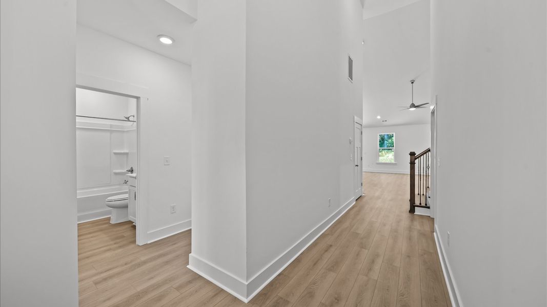 Exceptional foyer with warm hardwood flooring and refined finishes throughout