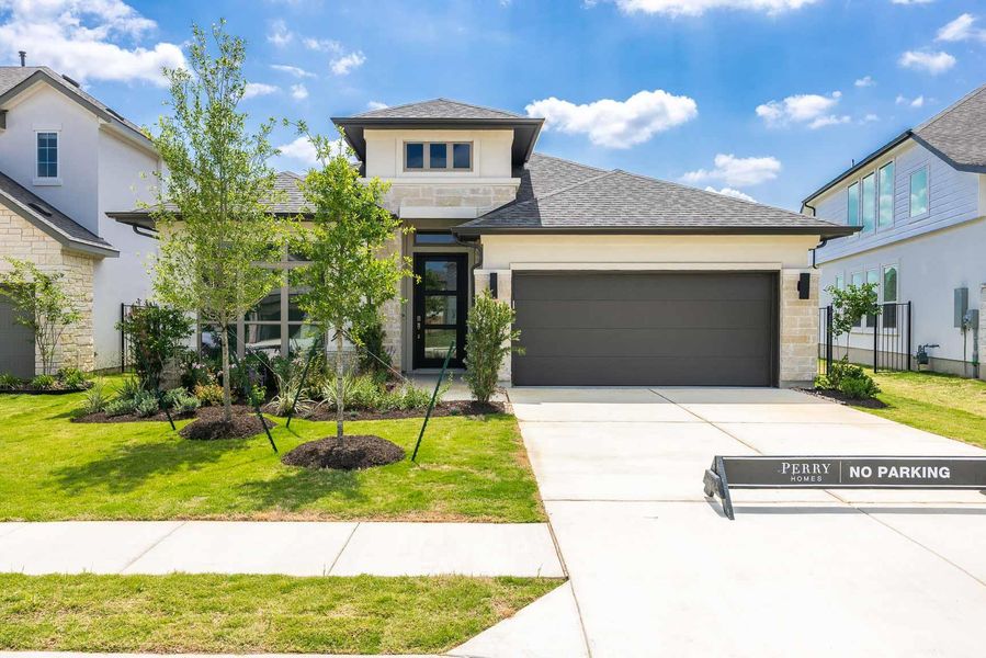 Prairie-style home with a shingled roof, stone siding, a front lawn, concrete driveway, and an attached garage Prairie-style home with a shingled roof, stone siding, a front lawn, concrete driveway, and an attached garage