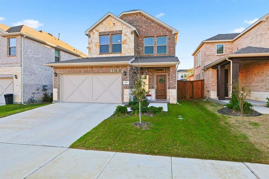 Front exterior of a new home in Spiritas Ranch, Little Elm, TX, highlighting curb appeal (Image 2). Front exterior of a new home in Spiritas Ranch, Little Elm, TX, highlighting curb appeal (Image 2).