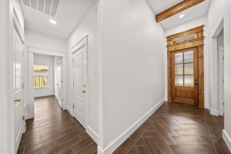 Foyer with beamed ceiling, dark wood-style floors, and recessed lighting Foyer with beamed ceiling, dark wood-style floors, and recessed lighting
