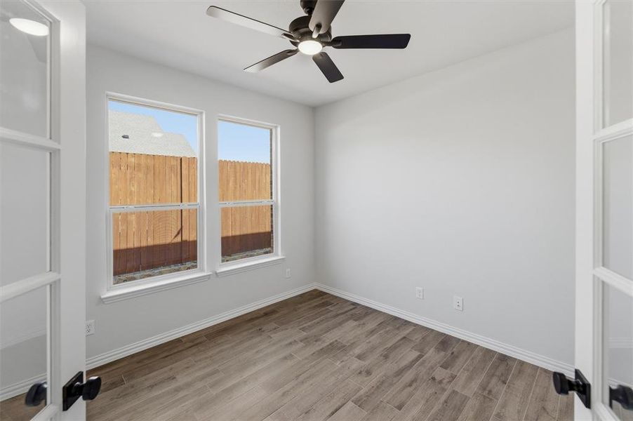 Unfurnished room featuring light wood-style floors and ceiling fan
