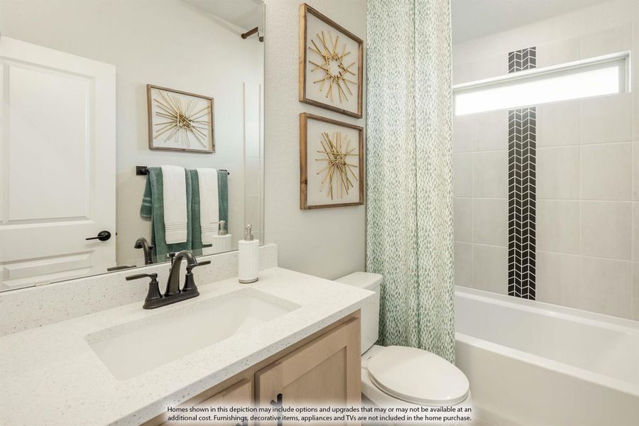 Bathroom with white quartz vanity, tub-shower combo with patterned curtain, and tiled surround with herringbone accent strip.