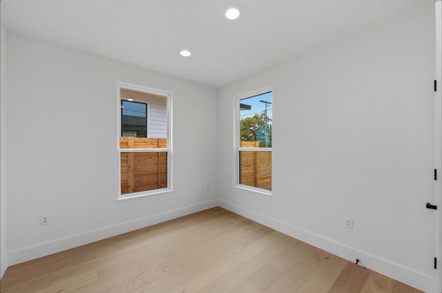 Spare room featuring light wood finished floors and recessed lighting