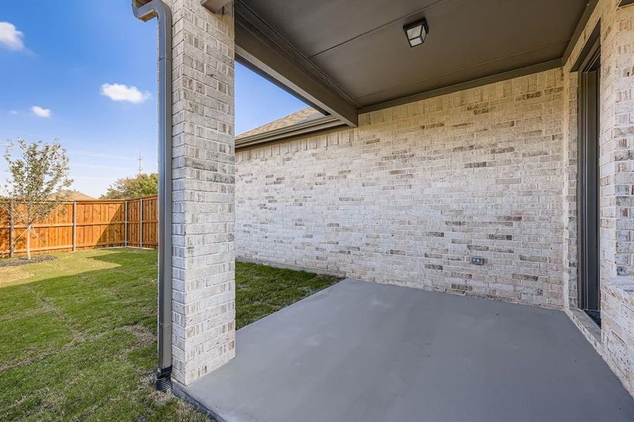 Fenced backyard featuring a patio