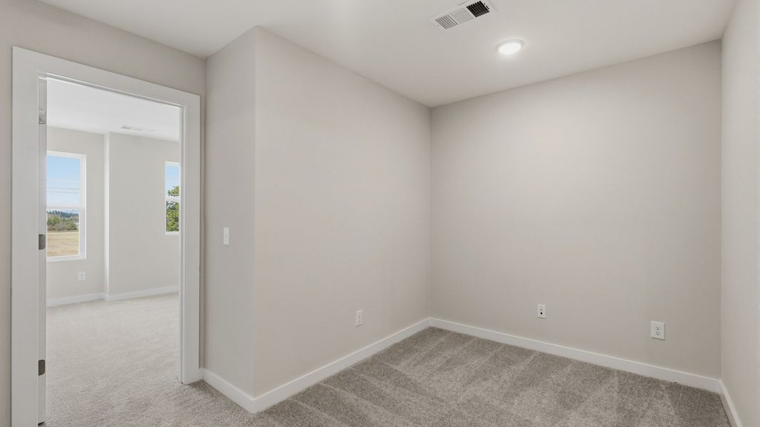 Versatile loft area with opening to hallway leading to staircase