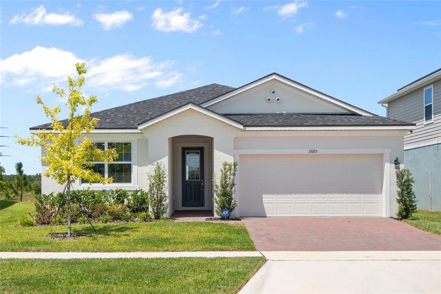 Front exterior of a new home in Waterbrooke, Clermont, FL, highlighting curb appeal (Image 2).