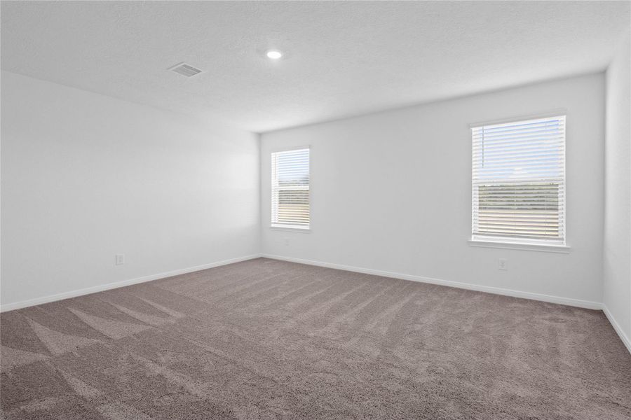 Relax and recharge in this stunning primary suite! Enjoy the comfort of plush carpeting, neutral-toned walls, high ceilings, recessed lighting, and large windows with privacy blinds that fill the room with natural light. Relax and recharge in this stunning primary suite! Enjoy the comfort of plush carpeting, neutral-toned walls, high ceilings, recessed lighting, and large windows with privacy blinds that fill the room with natural light.