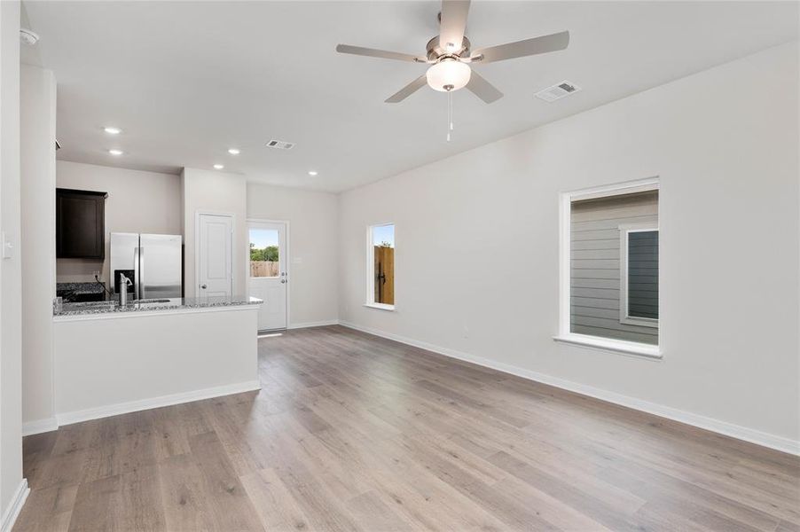 Unfurnished living room with light wood finished floors, recessed lighting, and ceiling fan Unfurnished living room with light wood finished floors, recessed lighting, and ceiling fan