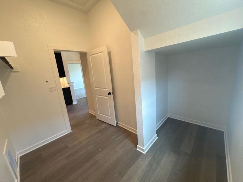 Hall with dark wood finished floors and baseboards Hall with dark wood finished floors and baseboards