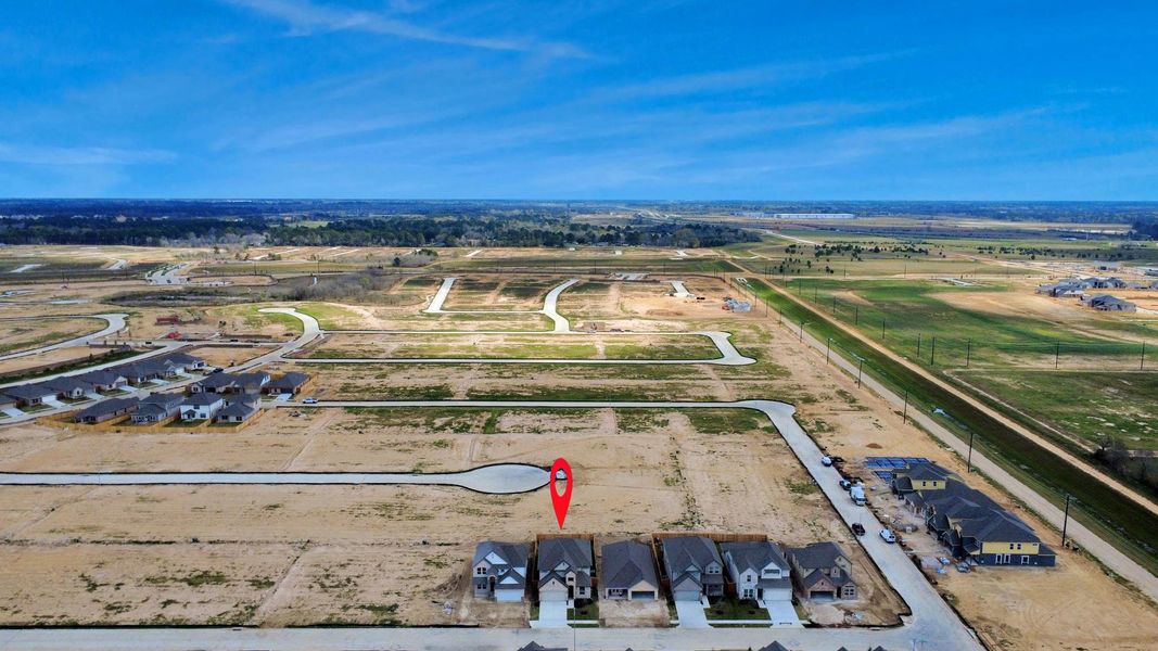 An aerial view of a spacious subdivision lot, highlighting a well-maintained yard and a fully fenced perimeter, offering both privacy and expansive outdoor space.