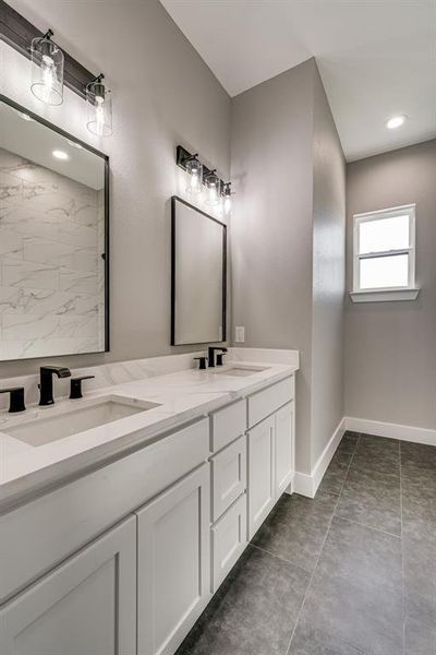 Bathroom featuring tile patterned floors and vanity