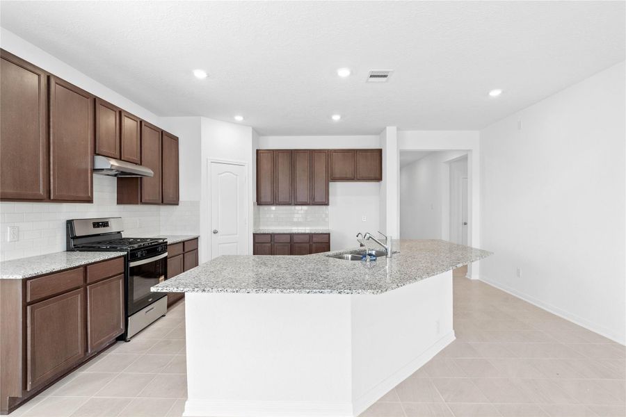 The extended breakfast bar provides additional seating—perfect for a quick meal—while keeping you connected to conversations in both the kitchen and Great Room.