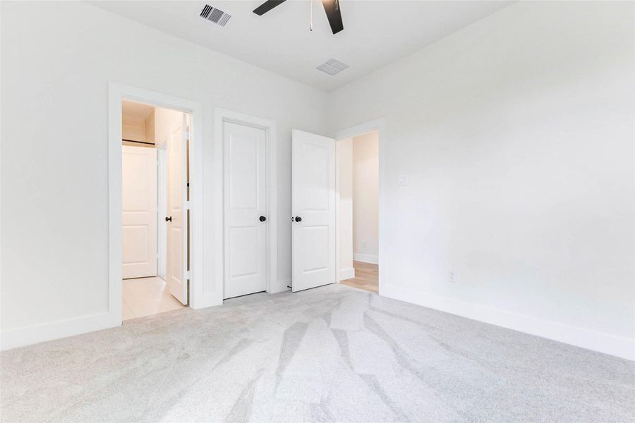 Bedroom 3 is a spacious secondary bedroom with natural light, modern fan, and large closet.