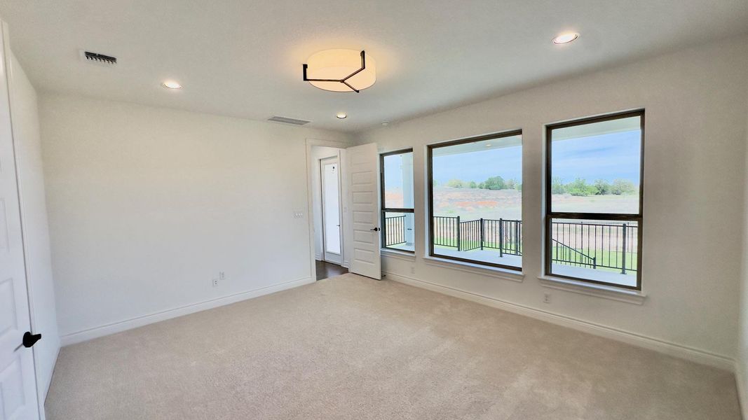 Spare room featuring light colored carpet and recessed lighting