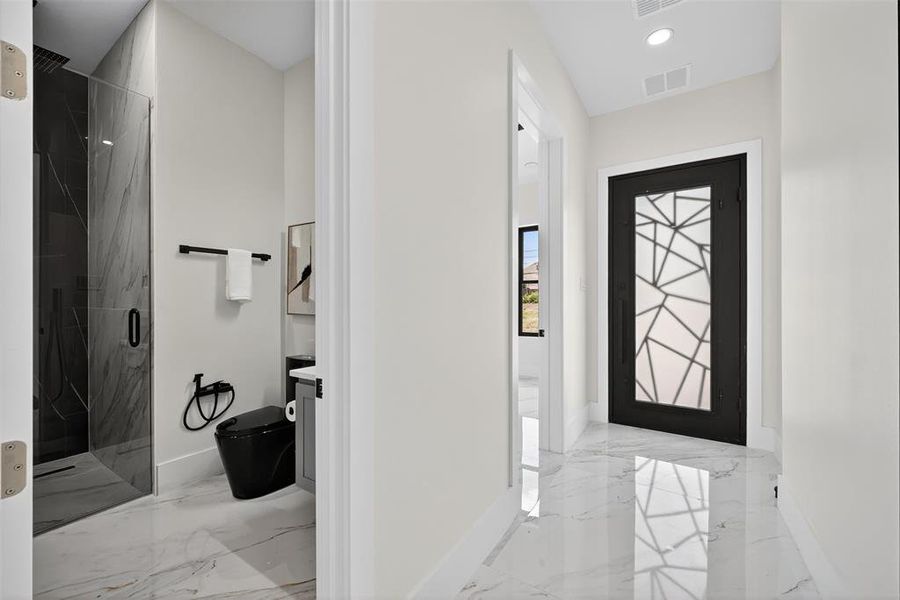 Foyer entrance featuring light marble finish floors and recessed lighting
