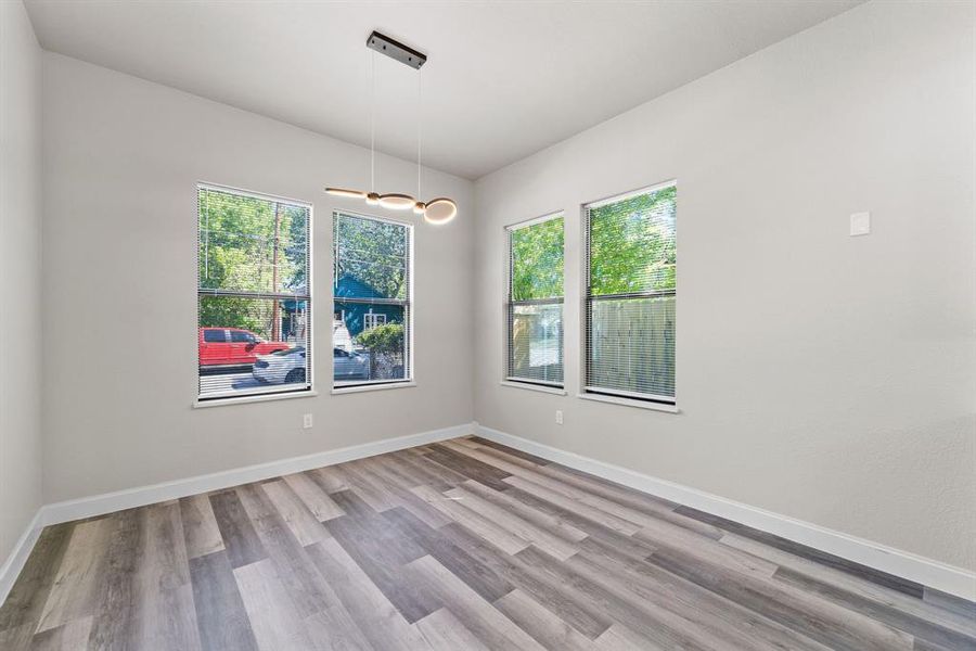 Spare room with a healthy amount of sunlight and light hardwood / wood-style floors