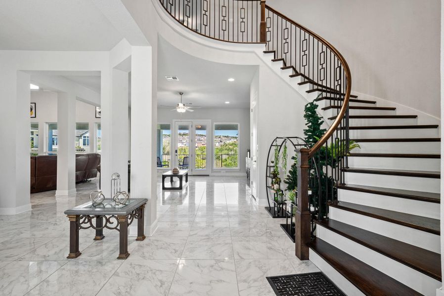 Entryway featuring light marble finish floors, a high ceiling, ceiling fan, and recessed lighting
