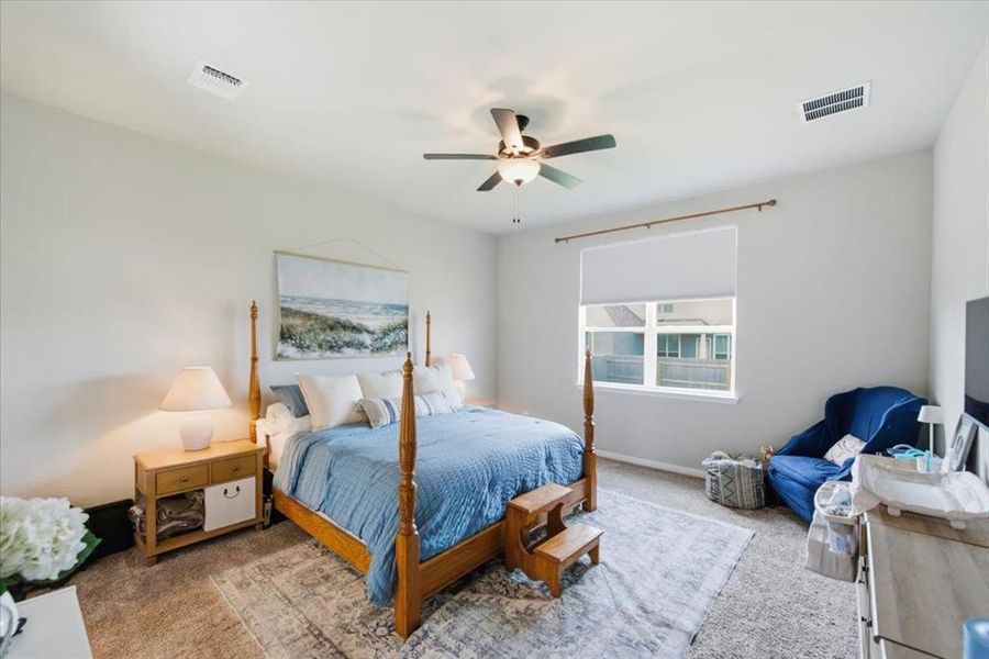 Bedroom with carpet floors and a ceiling fan Bedroom with carpet floors and a ceiling fan