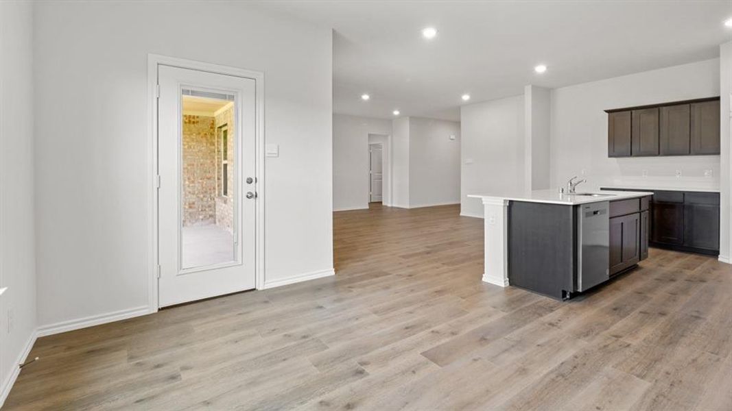 Open-concept living space featuring wood-finish flooring and recessed lighting