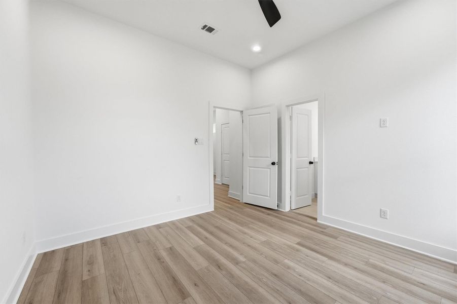 Another view of this spacious bedroom with recessed lighting, ceiling fan, and wide-plank LVP flooring, offering the flexibility to become whatever you need: a bedroom, home office, media room, or more. Another view of this spacious bedroom with recessed lighting, ceiling fan, and wide-plank LVP flooring, offering the flexibility to become whatever you need: a bedroom, home office, media room, or more.
