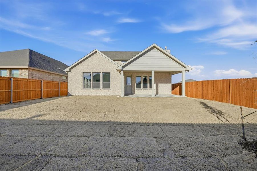 Rear view of house featuring a fenced backyard, a patio area, and brick siding Rear view of house featuring a fenced backyard, a patio area, and brick siding