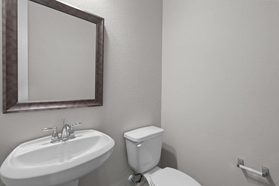 This charming home features a beautifully appointed half bath adjacent to the family room, perfect for welcoming guests and adding convenience to your daily life.
