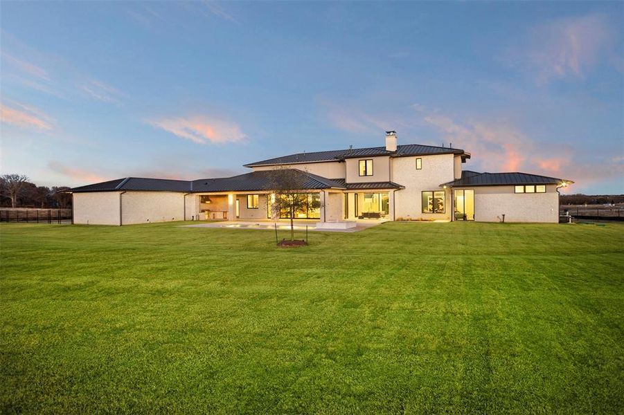 View of back of home.  Ample yard space waiting for your touch.