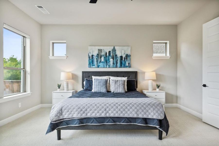 Bedroom featuring ceiling fan and light carpet