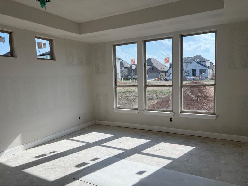 Empty room with a residential view and a raised ceiling Empty room with a residential view and a raised ceiling