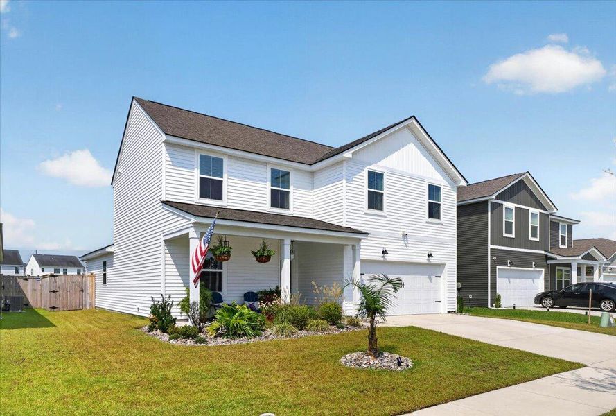 Front exterior of a new home in Sanctuary Cove at Cane Bay, Summerville, SC, highlighting curb appeal (Image 24).