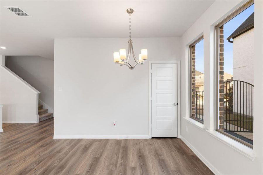 Adjacent to the kitchen, this lovely dining area is the perfect place for cozy family meals or fun dinner parties!