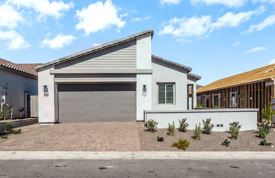 Front exterior of a new home in Regent Hills - Meadow Series, Buckeye, AZ, highlighting curb appeal (Image 1). Front exterior of a new home in Regent Hills - Meadow Series, Buckeye, AZ, highlighting curb appeal (Image 1).