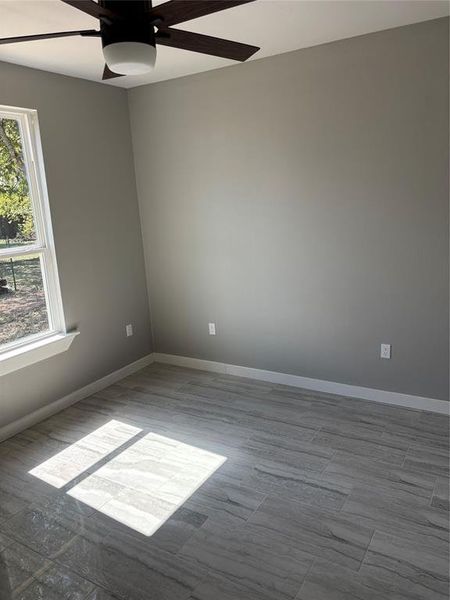 Spare room featuring ceiling fan and wood tiled floors Spare room featuring ceiling fan and wood tiled floors