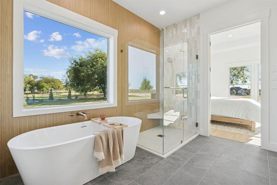 Picture window frames the stand-alone tub. It feels like your own personal spa in here.