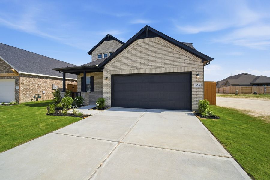 Front exterior of a new home in Wildrye, Waller, TX, highlighting curb appeal (Image 20). Front exterior of a new home in Wildrye, Waller, TX, highlighting curb appeal (Image 20).