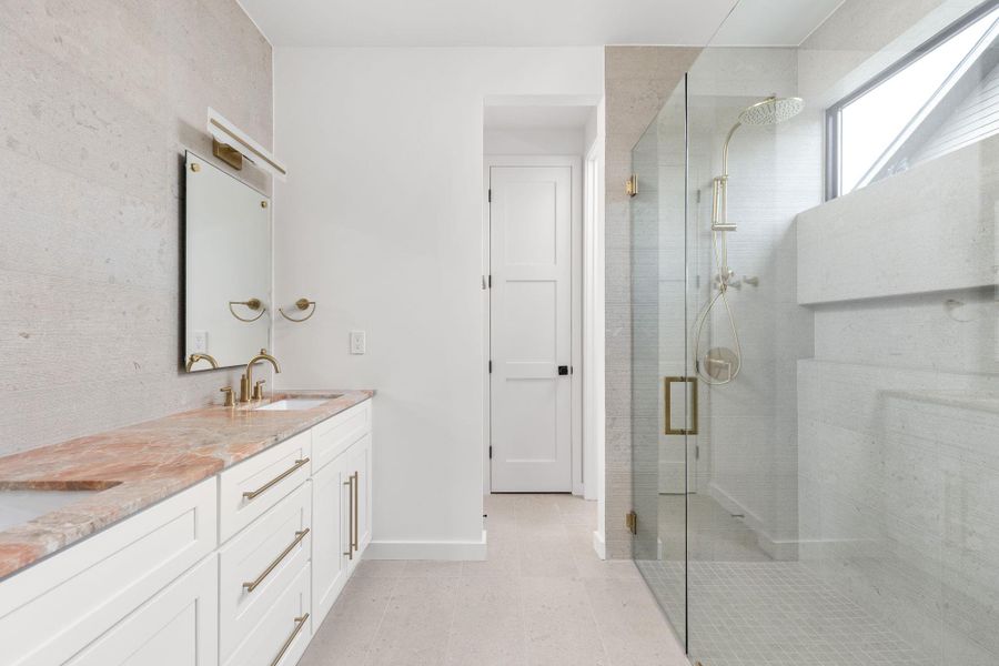 Full bathroom featuring a shower stall and double vanity