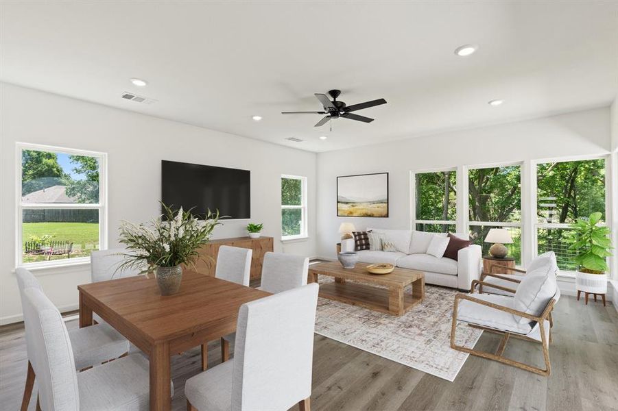 Living room featuring plenty of natural light, wood finished floors, and recessed lighting Living room featuring plenty of natural light, wood finished floors, and recessed lighting