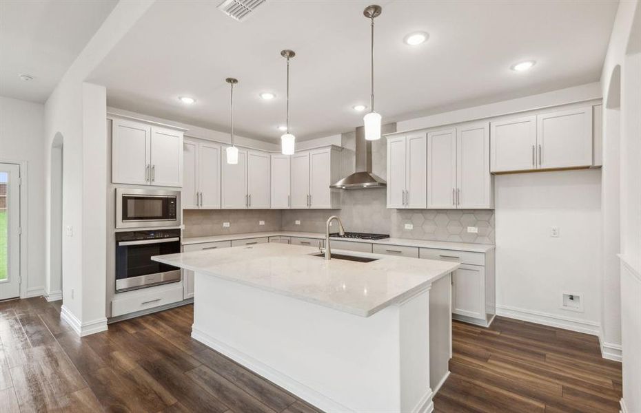 Bright kitchen with oversized island *real home pictured