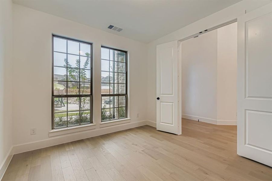 Unfurnished bedroom featuring light wood-style flooring and baseboards Unfurnished bedroom featuring light wood-style flooring and baseboards