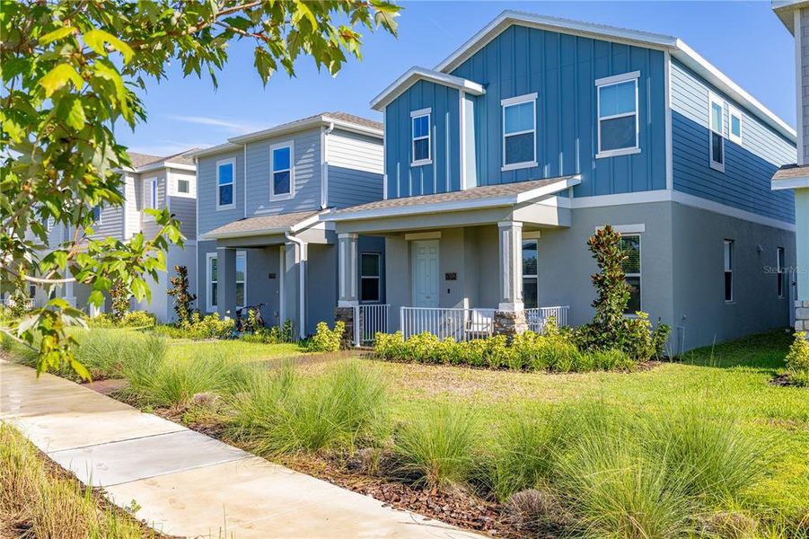 Front exterior of a new home in Serenade at Ovation, Winter Garden, FL, highlighting curb appeal (Image 21). Front exterior of a new home in Serenade at Ovation, Winter Garden, FL, highlighting curb appeal (Image 21).