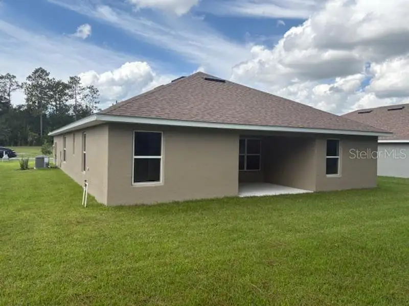 Front exterior of a new home in Juliette Falls, Dunnellon, FL, highlighting curb appeal (Image 10).