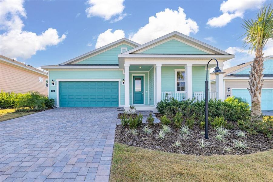 Front exterior of a new home in Green Key Village, Lady Lake, FL, highlighting curb appeal (Image 1).