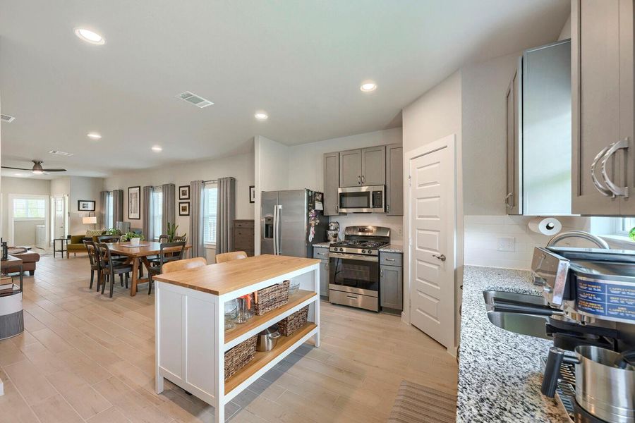 An open concept design seamlessly connects the kitchen to dining and living areas, fostering easy entertaining. An open concept design seamlessly connects the kitchen to dining and living areas, fostering easy entertaining.
