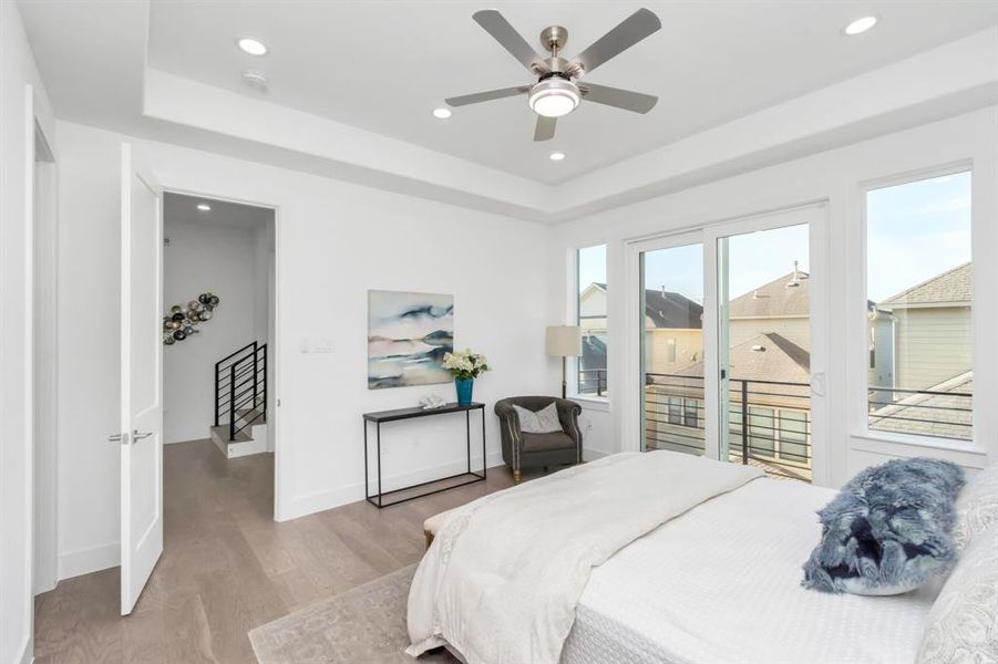 Primary bedroom with tons of natural light flooding in.