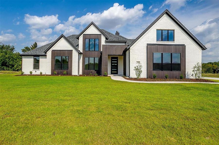 Modern farmhouse with a front lawn