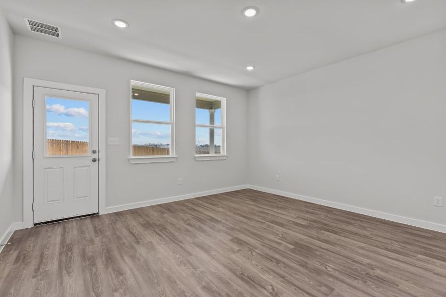 A room with a wood floor and white walls.