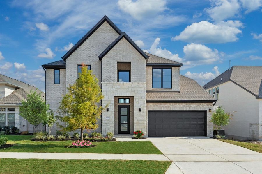 View of front of house with driveway, brick siding, a front lawn, stone siding, and roof with shingles View of front of house with driveway, brick siding, a front lawn, stone siding, and roof with shingles