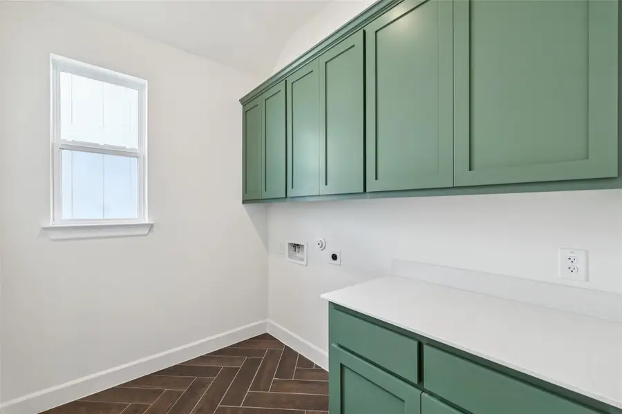 Washroom with cabinet space, hookup for an electric dryer, and washer hookup