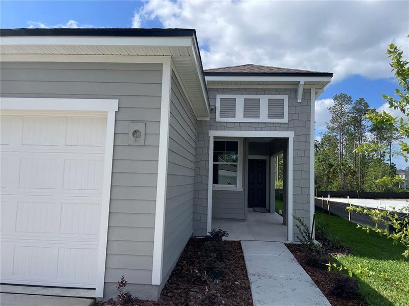 Front exterior of a new home in Palm Series at Seminole Palms, Palm Coast, FL, highlighting curb appeal (Image 1).