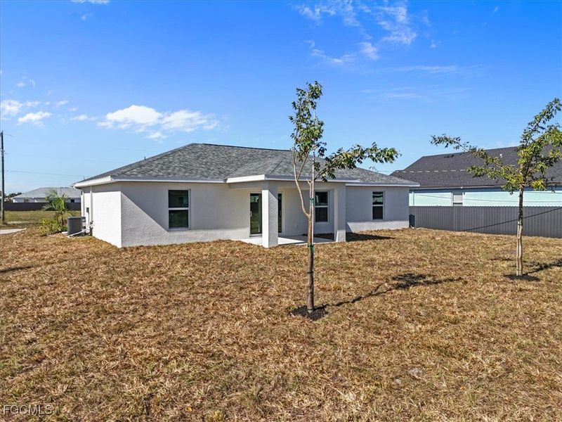 Back of house with stucco siding and a patio area
